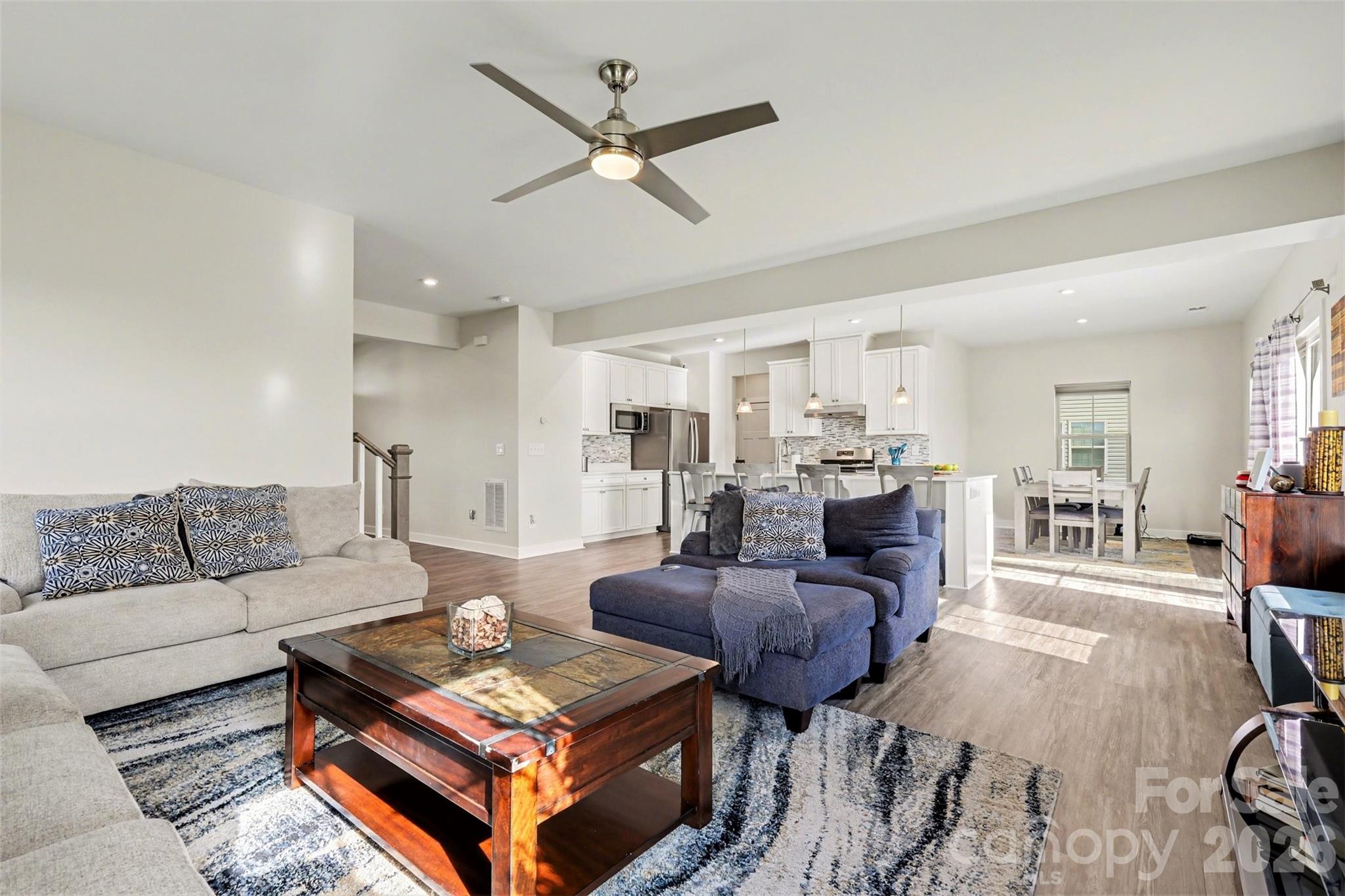 1840 Scarbrough Circle Southwest Concord, NC 28025 - Photo 5 of 29 a living room with furniture a ceiling fan and a rug