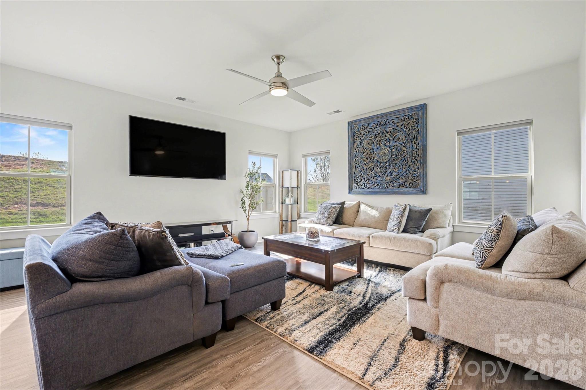 1840 Scarbrough Circle Southwest Concord, NC 28025 - Photo 6 of 29 a living room with furniture a flat screen tv and a large window