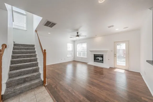 wooden floor in an empty room with a fireplace
