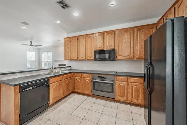 a kitchen with stainless steel appliances granite countertop a refrigerator sink and cabinets
