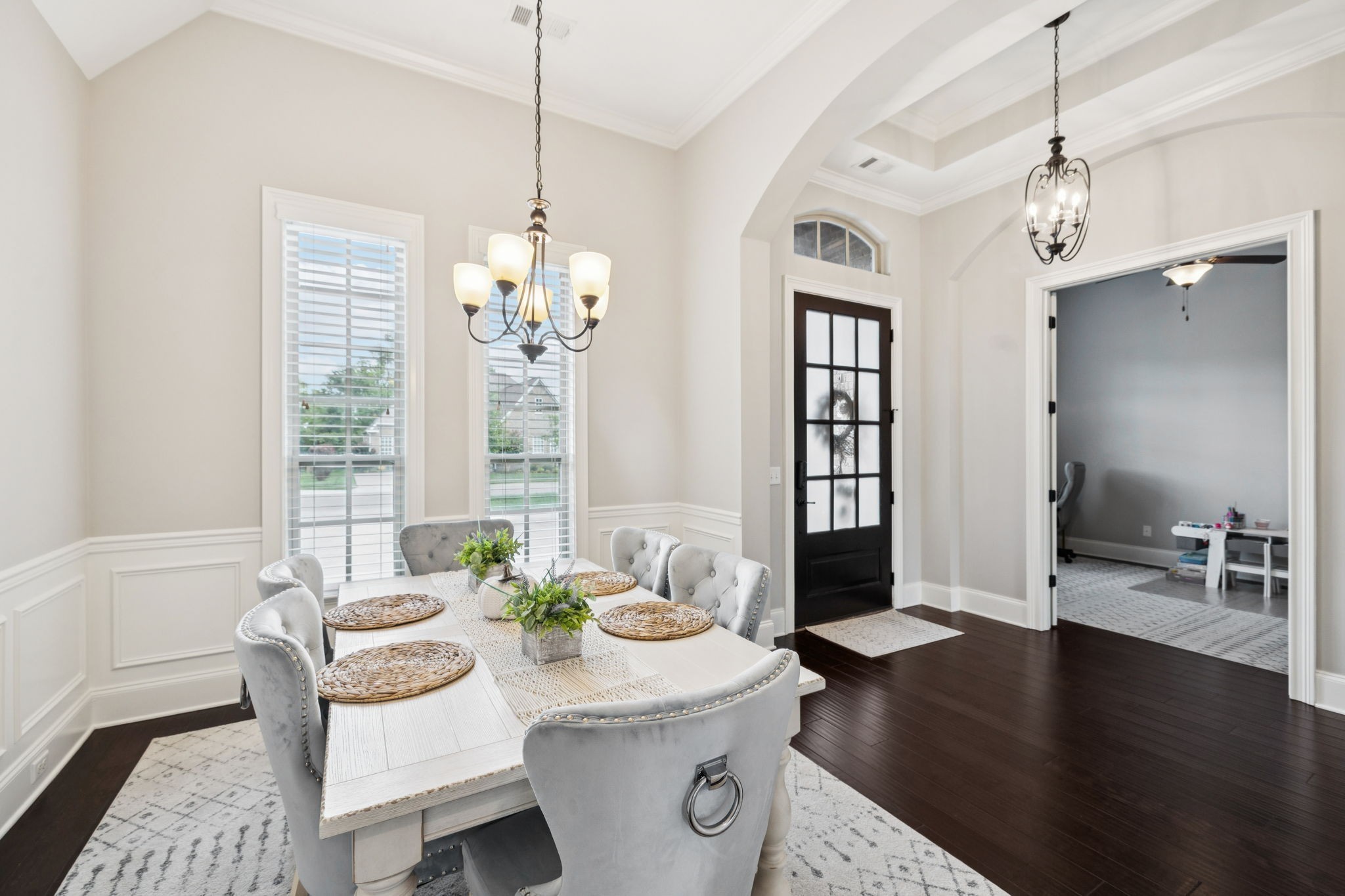 3639 Martins Mill Road Thompson's Station, TN 37179 - Photo 13 of 35 a dining room with wooden floor a chandelier a glass table and chairs