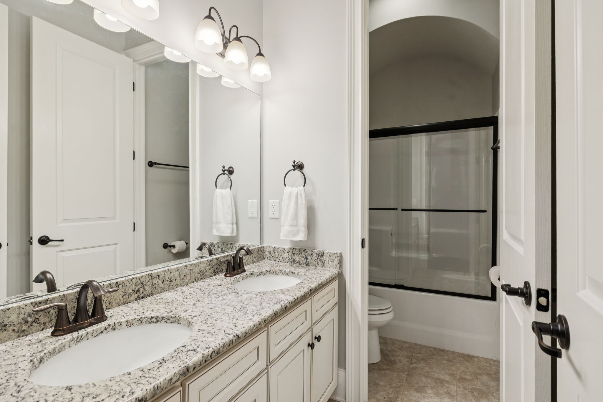 3639 Martins Mill Road Thompson's Station, TN 37179 - Photo 28 of 35 a bathroom with a granite countertop sink a toilet and mirror