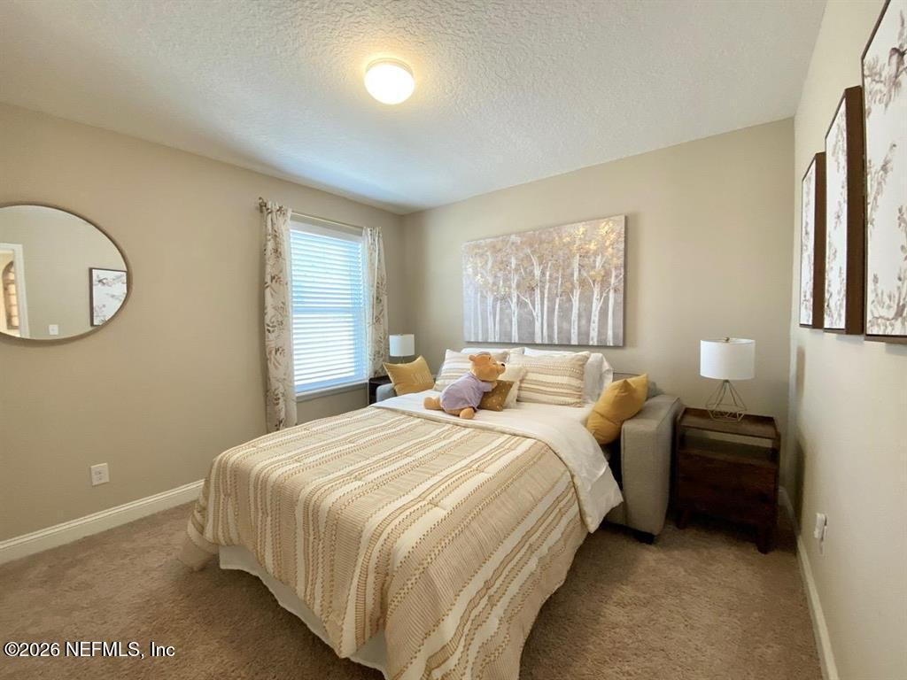 115 Sierras Loop St. Augustine, FL 32086 - Photo 38 of 65 a bedroom with bed and a window