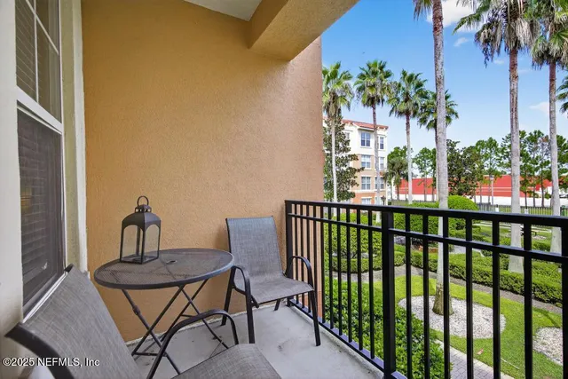 a view of a garden with a fountain and potted plants