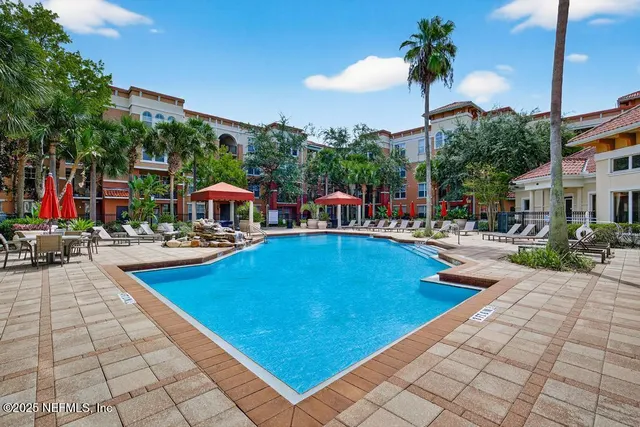 a building outdoor space with patio furniture and potted plants