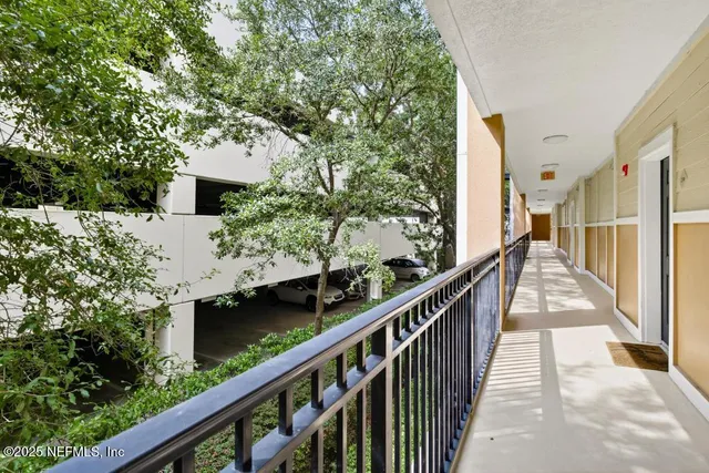 a view of balcony with wooden floor and fence
