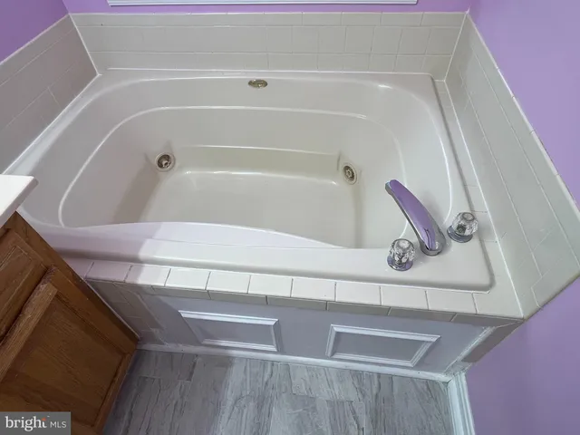 a bathroom with a bathtub sink and window