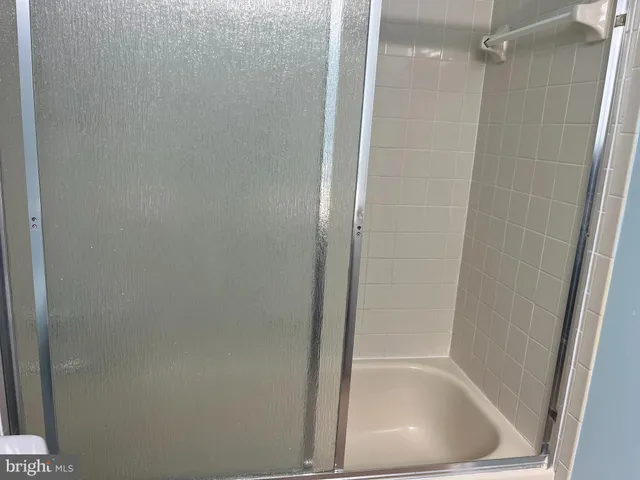 a view of an empty room with a fireplace and a projector