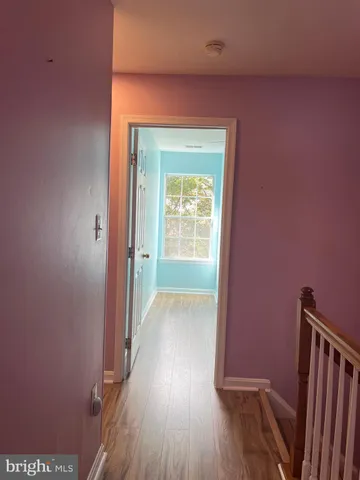 a front view of a house with a tree