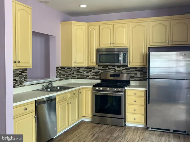 a kitchen with a stove a sink and a microwave