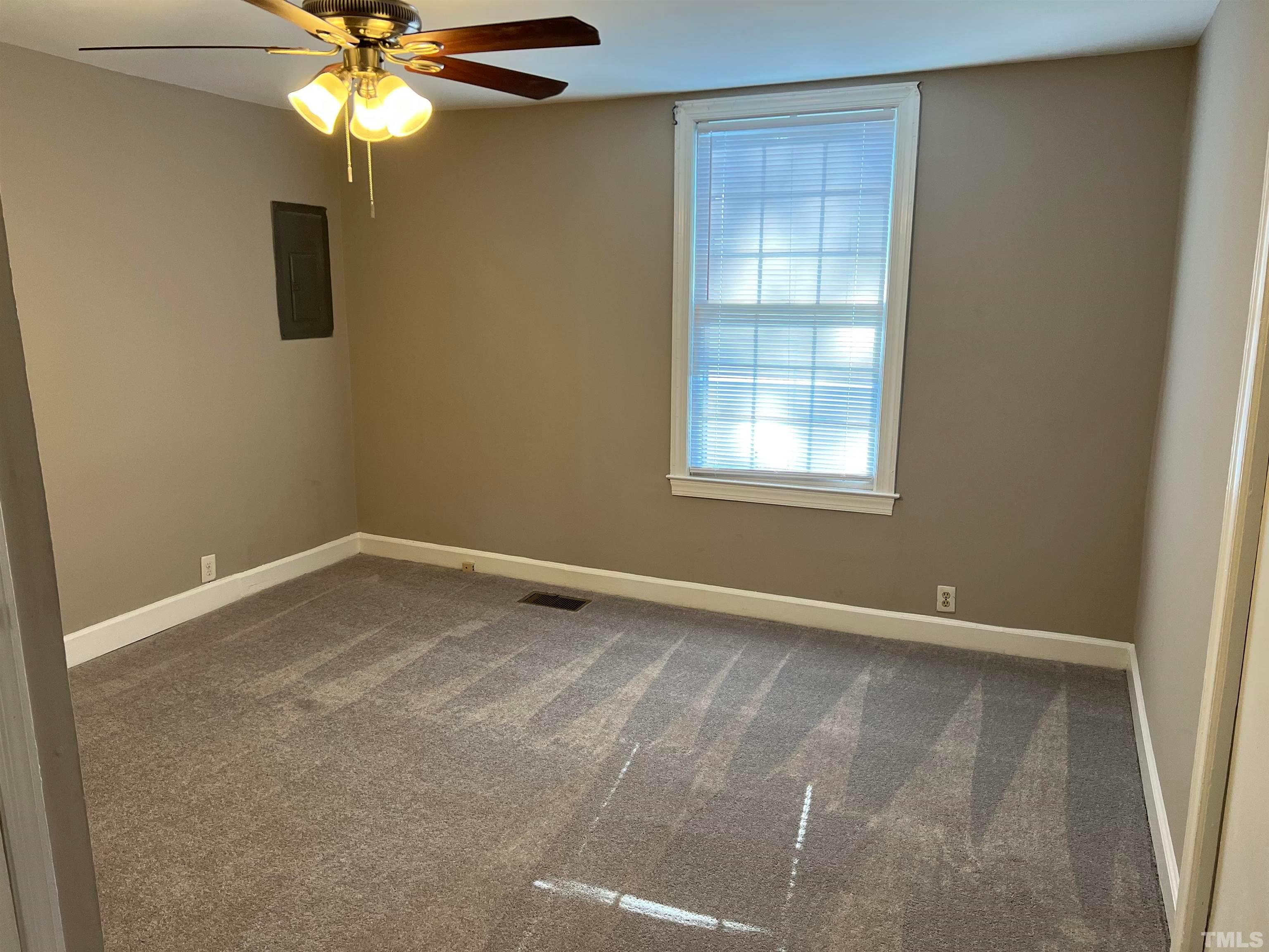 4359 Old Poole Road Raleigh, NC 27610 - Photo 9 of 13 an empty room with windows and fan