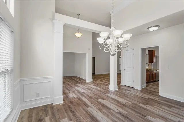 a view of a room with wooden floor and window