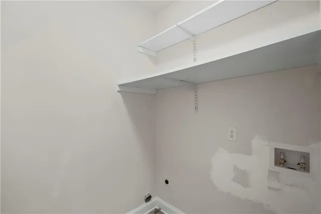 a large kitchen with stainless steel appliances granite countertop a stove and a wooden cabinets