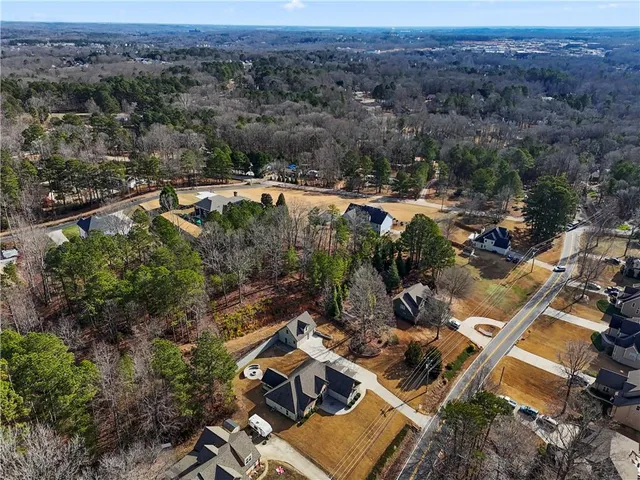 an aerial view of a house with a yard