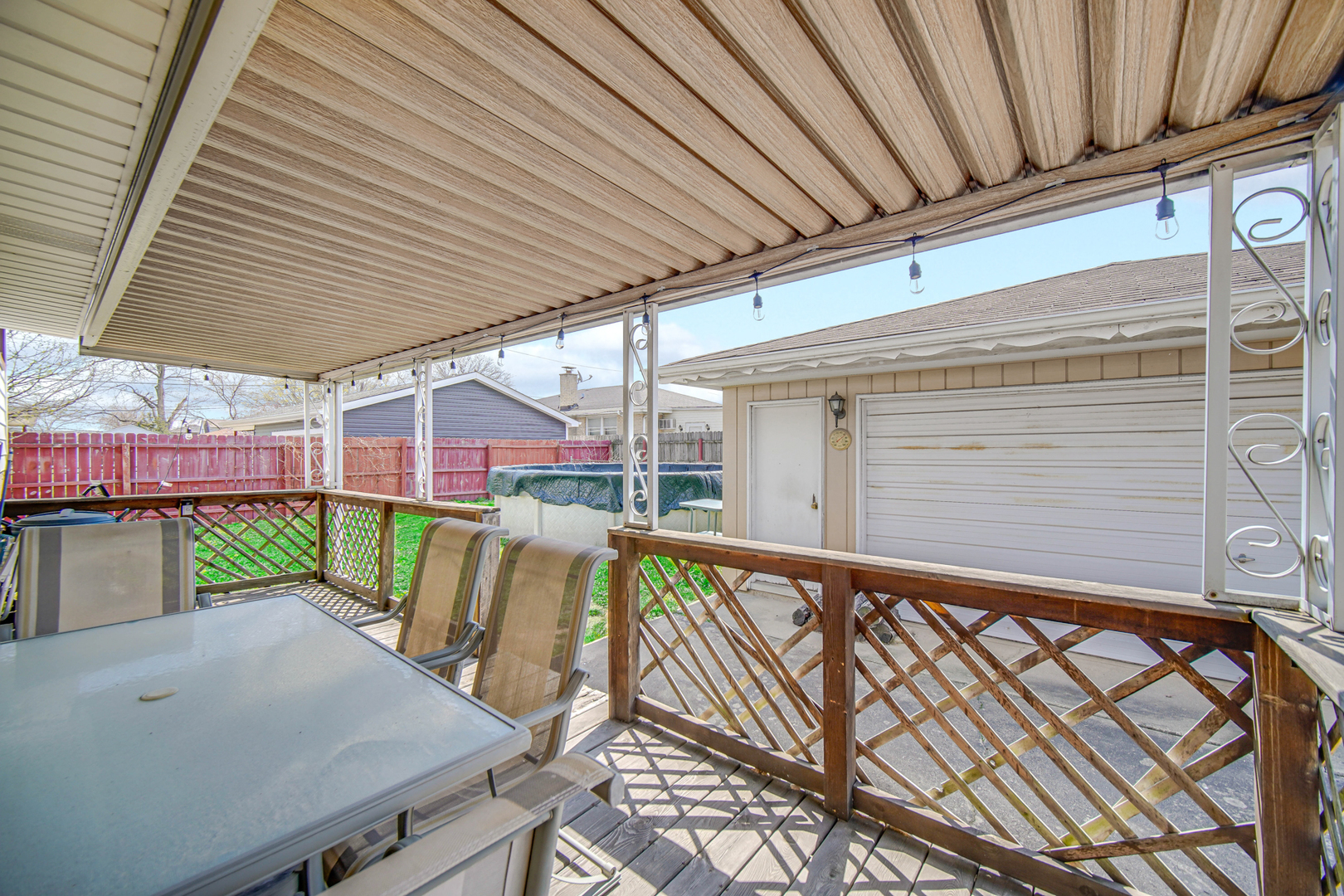 7305 West 75th Street Bridgeview, IL 60455 - Photo 17 of 22 a view of a patio with table and chairs with wooden floor and fence
