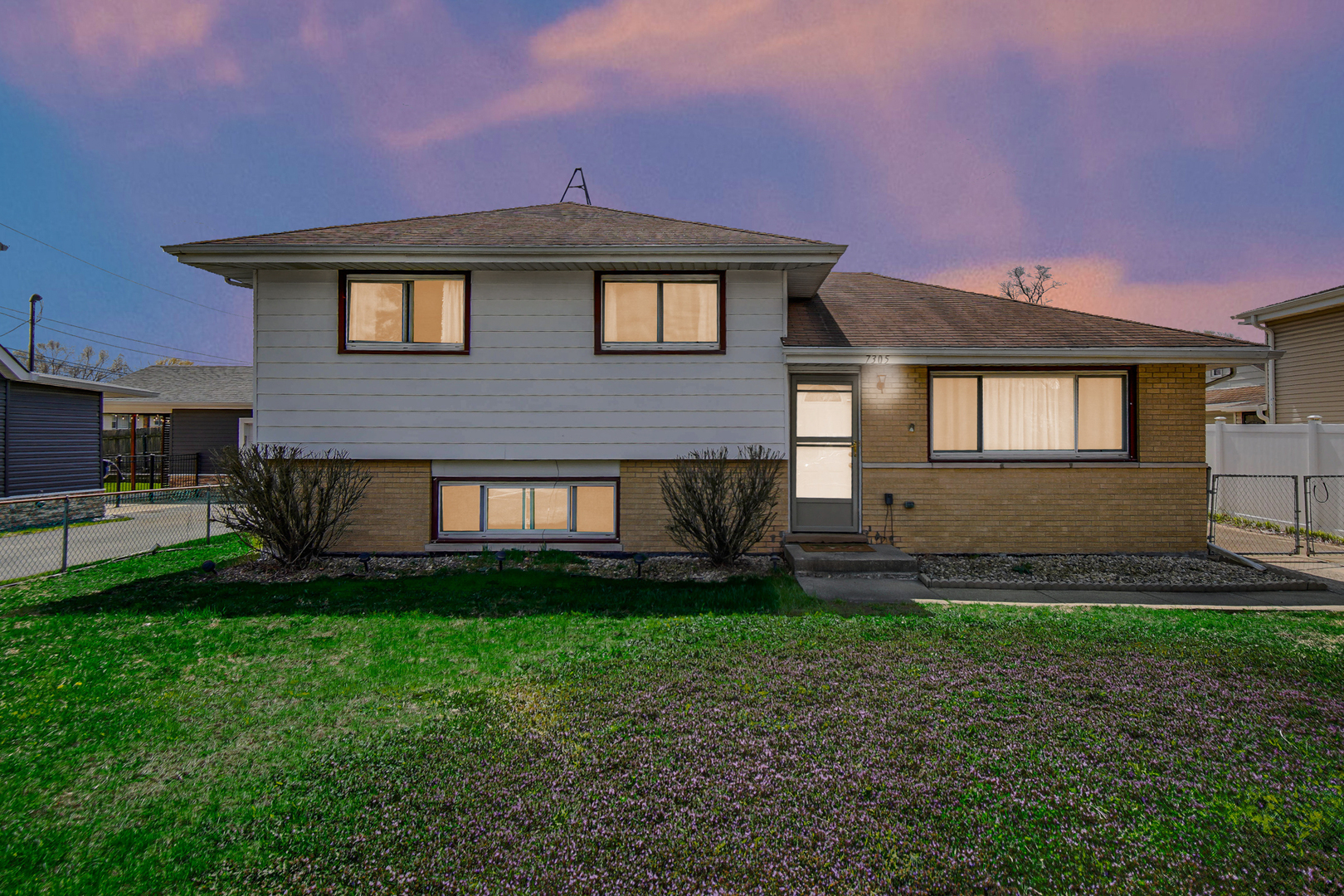 7305 West 75th Street Bridgeview, IL 60455 - Photo 3 of 22 a front view of a house with a yard
