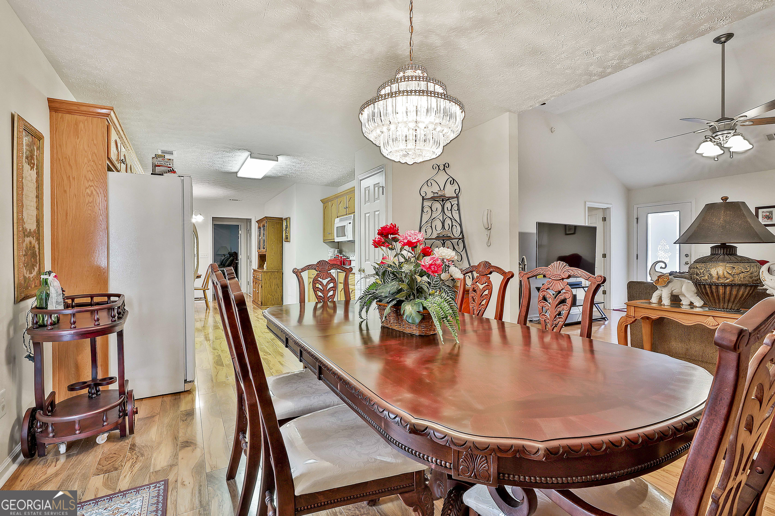 450 McKoy Road Newnan, GA 30263 - Photo 11 of 28 a dining room with furniture a chandelier and wooden floor