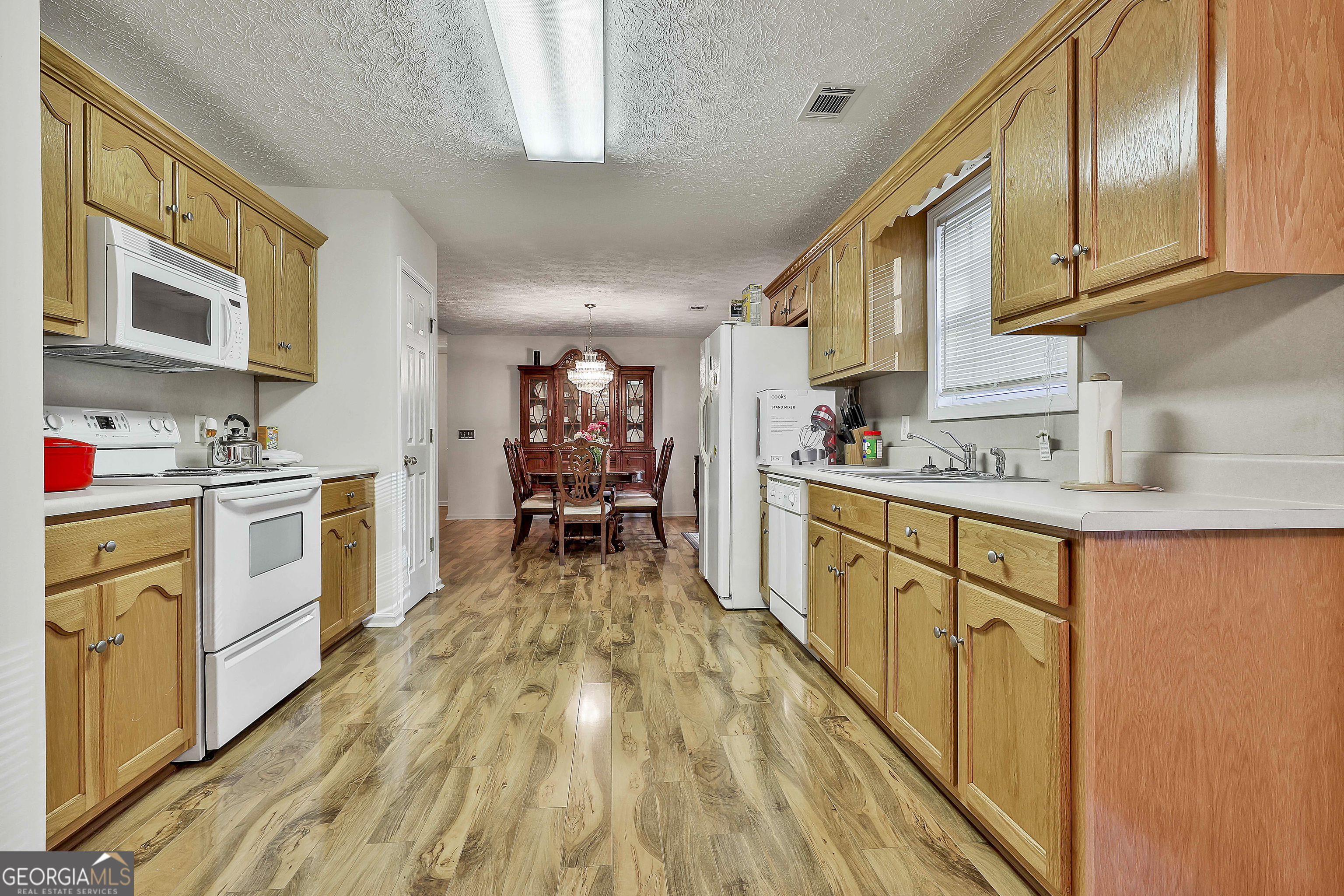 450 McKoy Road Newnan, GA 30263 - Photo 16 of 28 a kitchen with cabinets a sink and white appliances