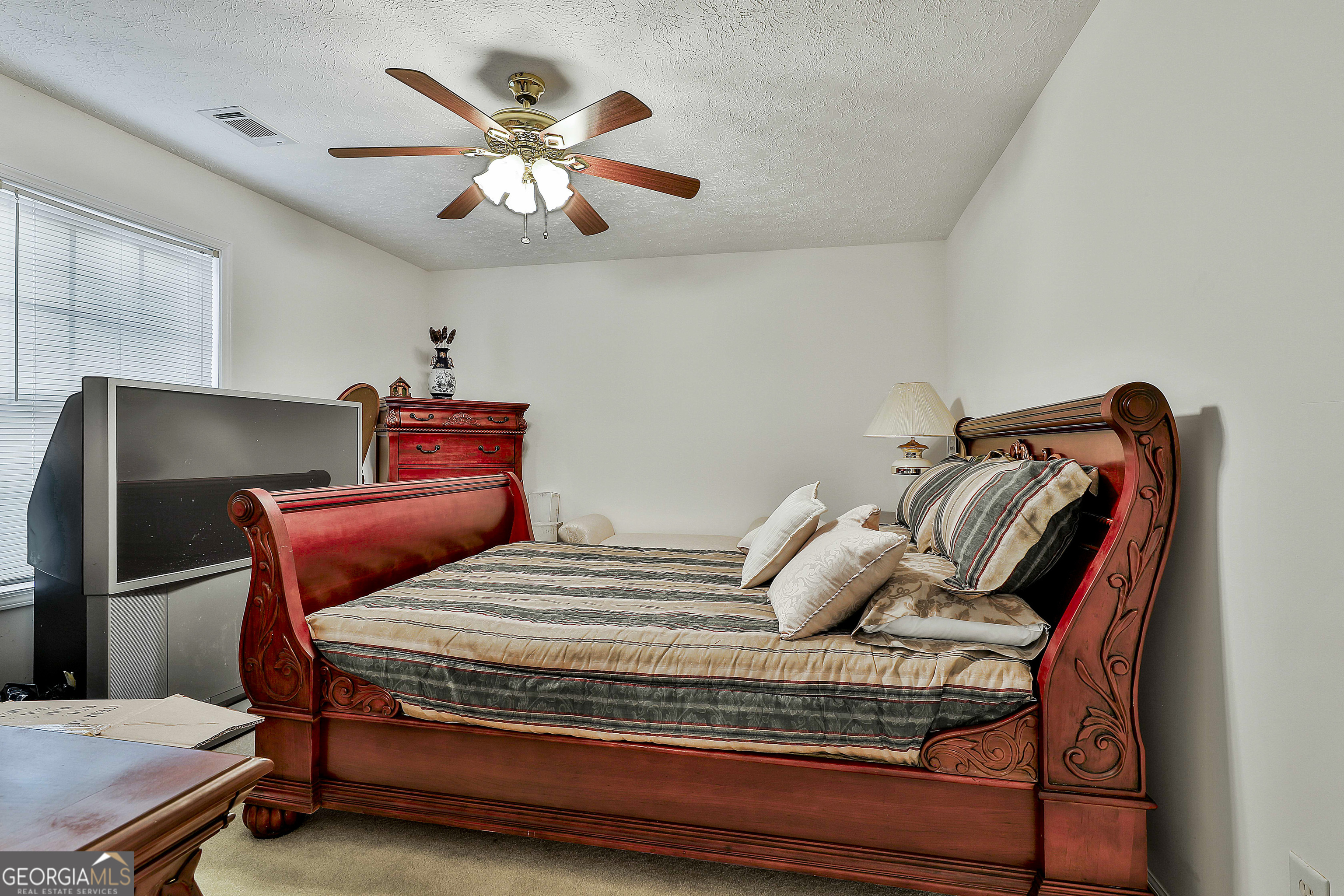 450 McKoy Road Newnan, GA 30263 - Photo 17 of 28 a bedroom with a bed and a chandelier