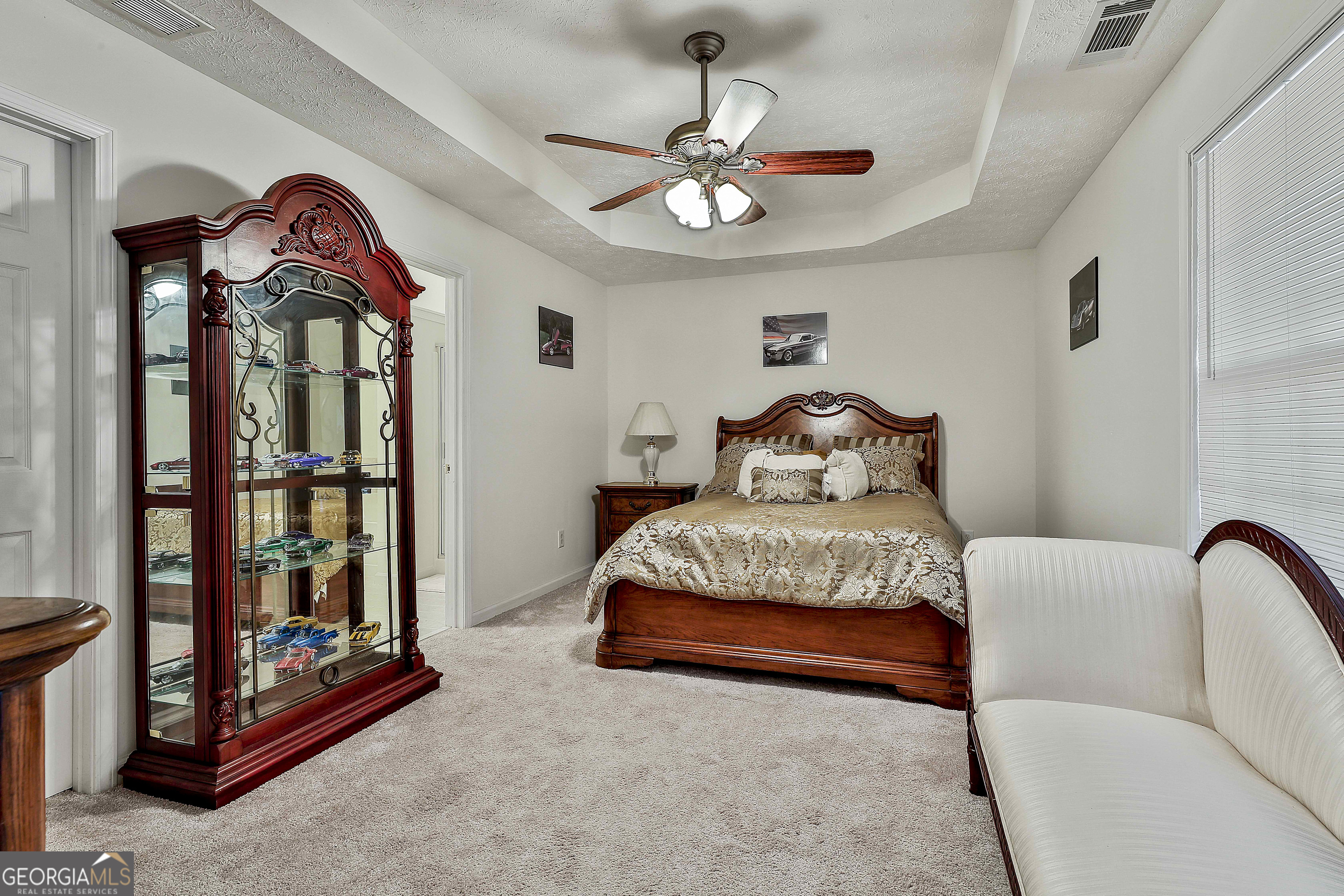 450 McKoy Road Newnan, GA 30263 - Photo 18 of 28 a bedroom with a bed and a chandelier