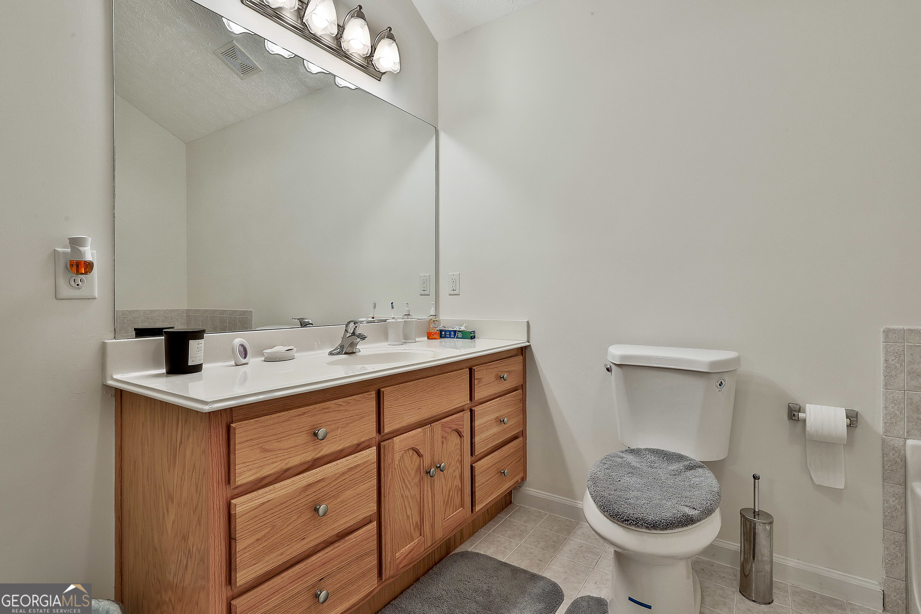 450 McKoy Road Newnan, GA 30263 - Photo 20 of 28 a bathroom with a sink and a toilet