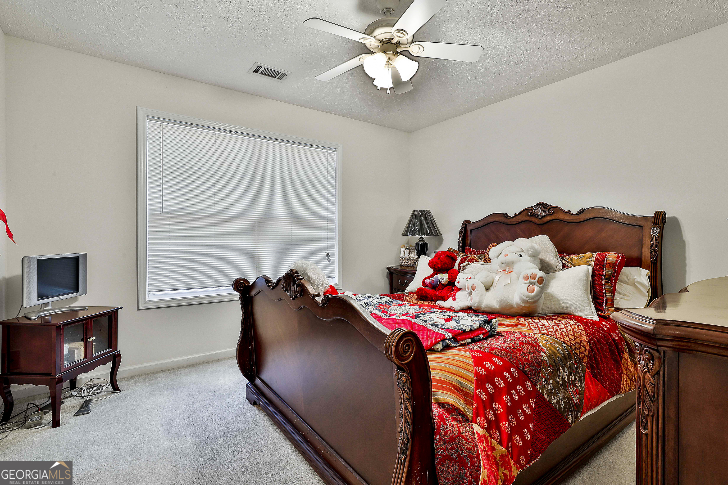 450 McKoy Road Newnan, GA 30263 - Photo 21 of 28 a bedroom with a bed and a chandelier