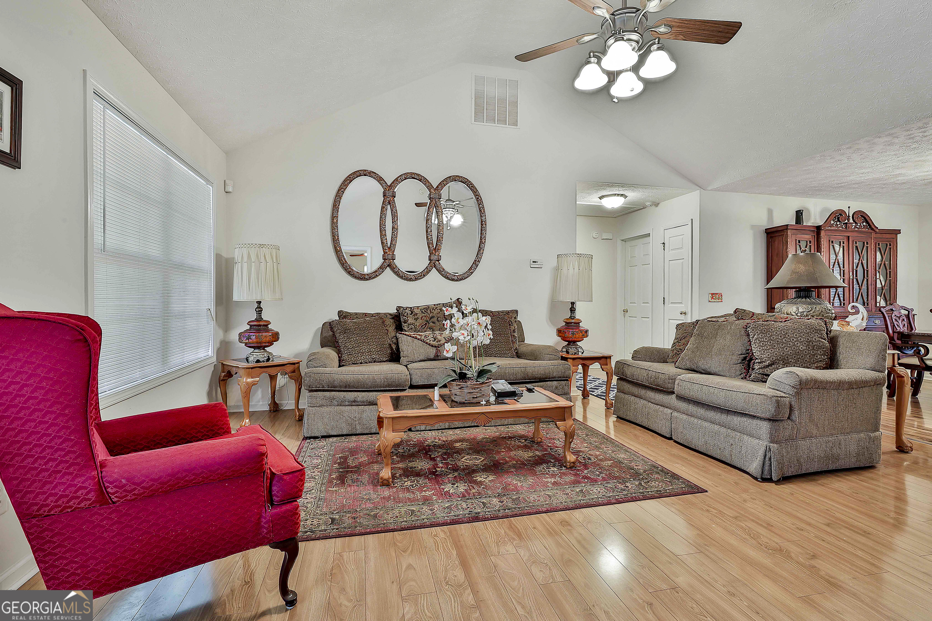 450 McKoy Road Newnan, GA 30263 - Photo 6 of 28 a living room with furniture a rug and a chandelier