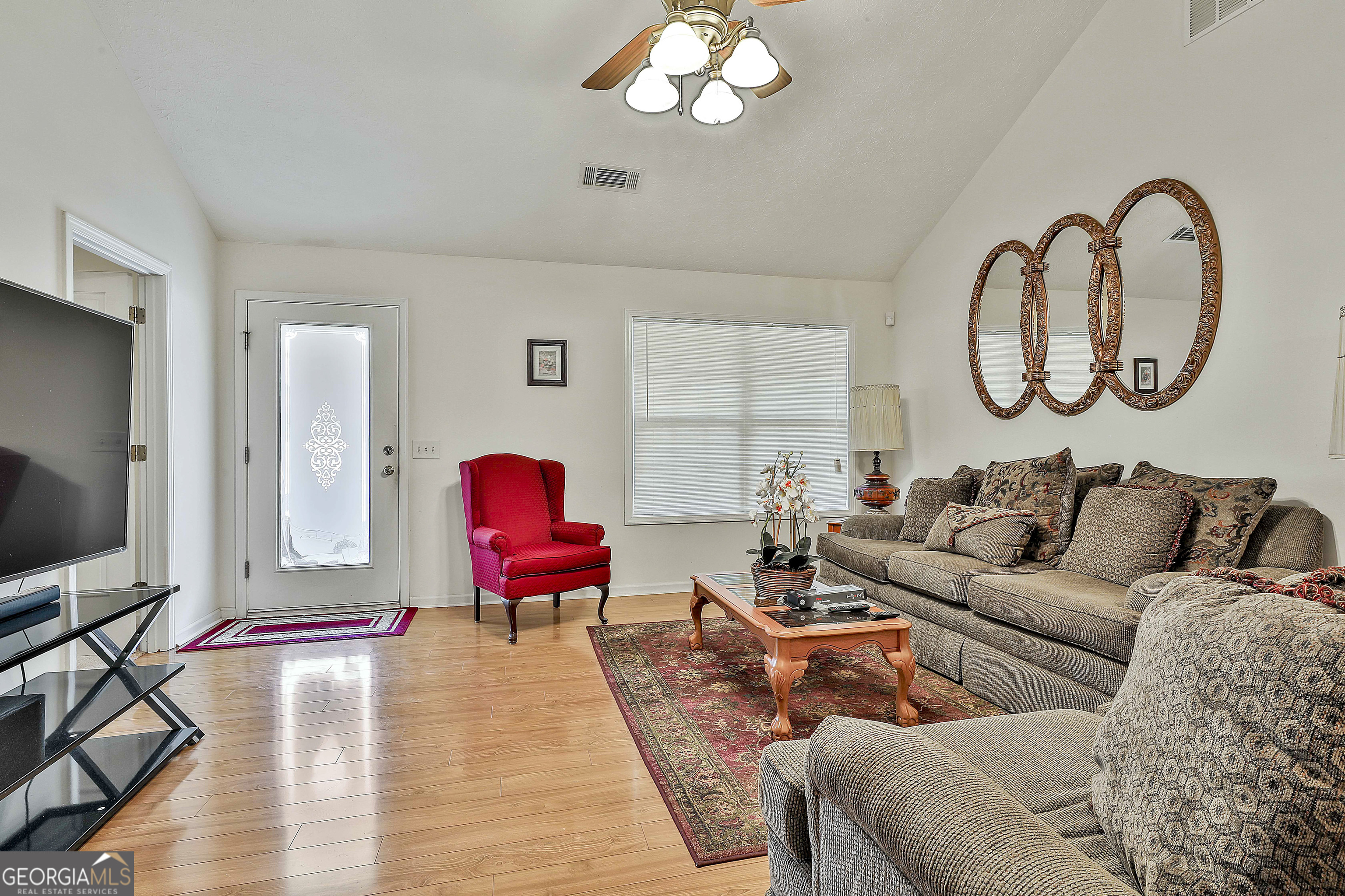 450 McKoy Road Newnan, GA 30263 - Photo 8 of 28 a living room with furniture a large window and a flat screen tv