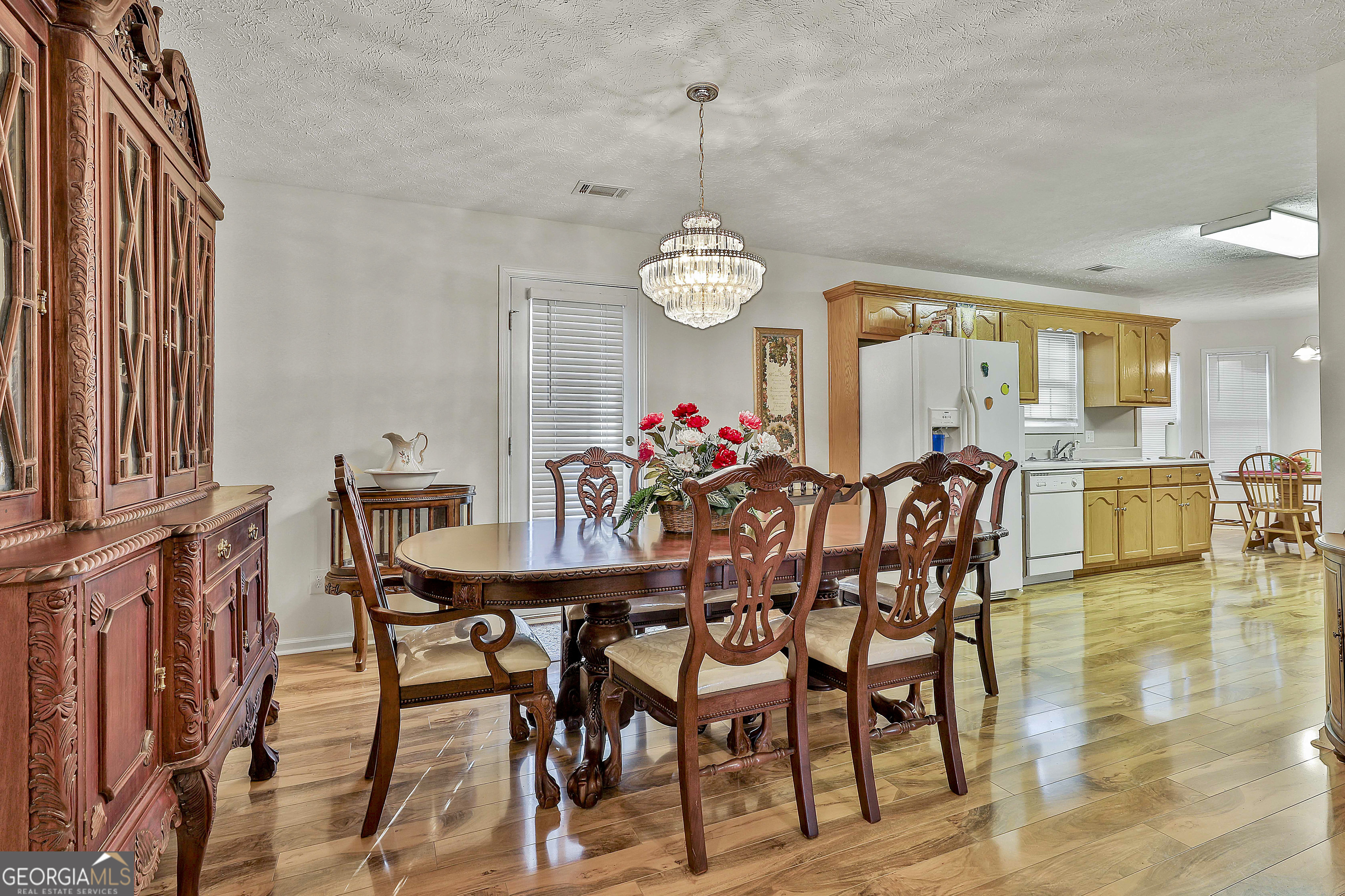 450 McKoy Road Newnan, GA 30263 - Photo 10 of 28 a view of a dining room and livingroom furniture wooden floor and a chandelier