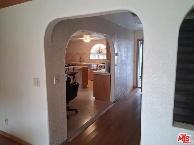 wooden floor in livingroom with a kitchen