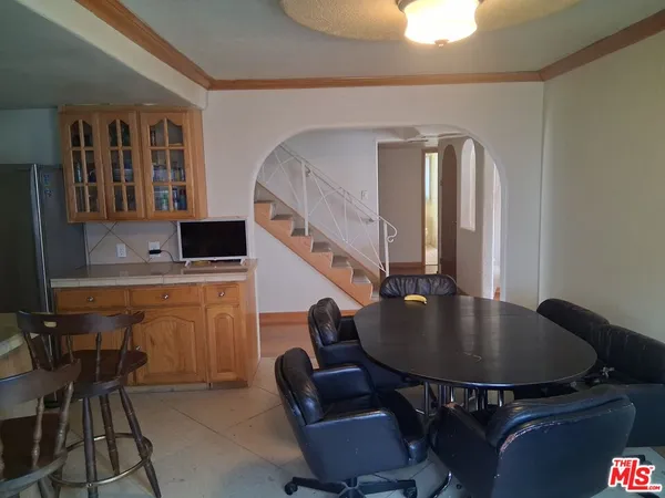 a kitchen with a table chairs and a dining table