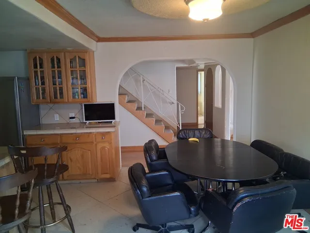 a kitchen with a table chairs and a dining table