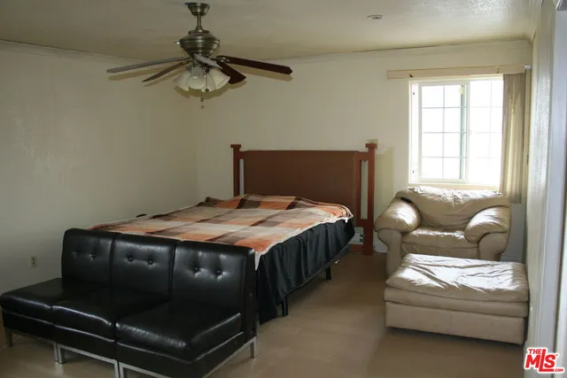 a bedroom with bed and window