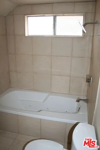 a bed sitting in a bedroom next to a cabinet