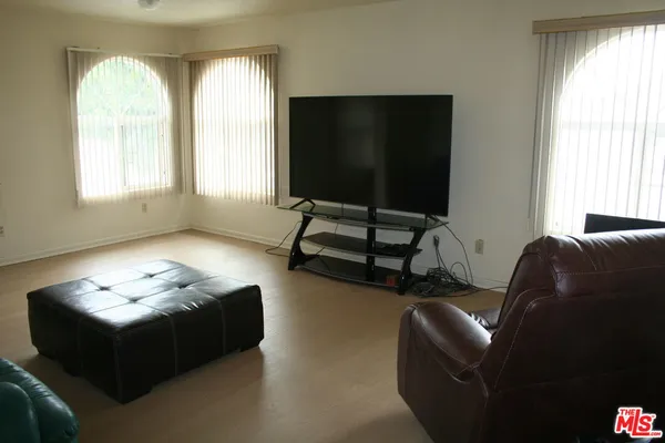 a view of a room that has a fan and a window