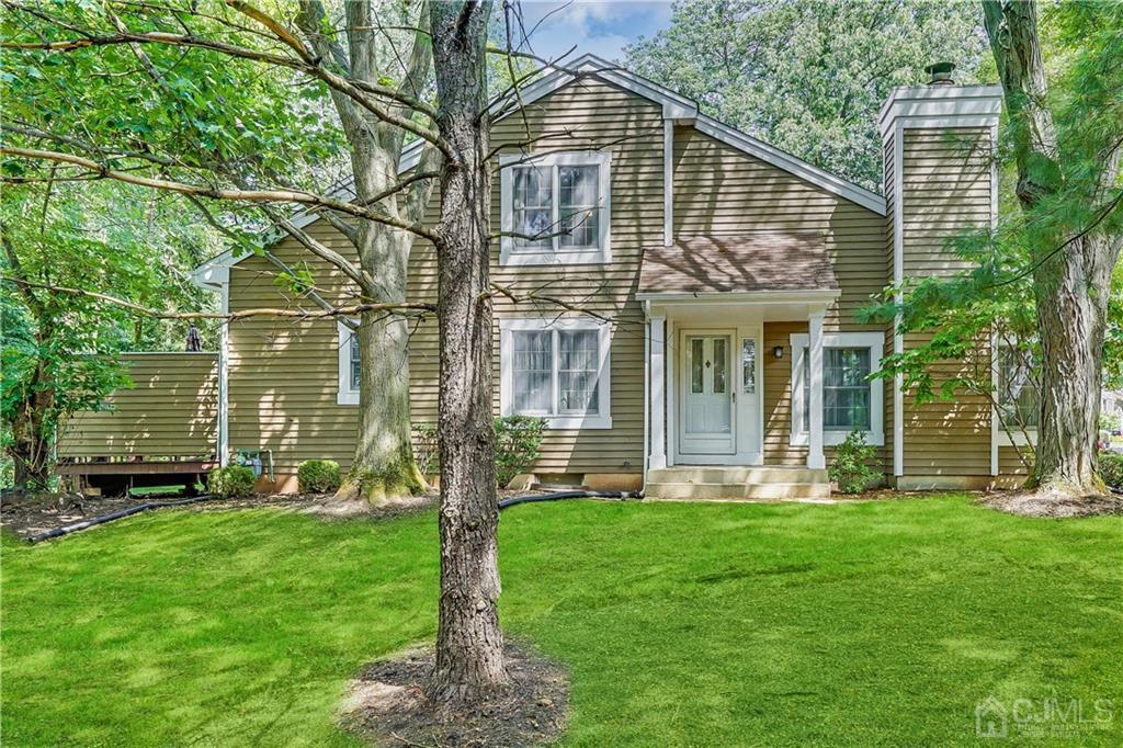 19 Stone Run Road Bedminster, NJ 07921 - Photo 1 of 17 a front view of a house with a yard potted plants and a garden