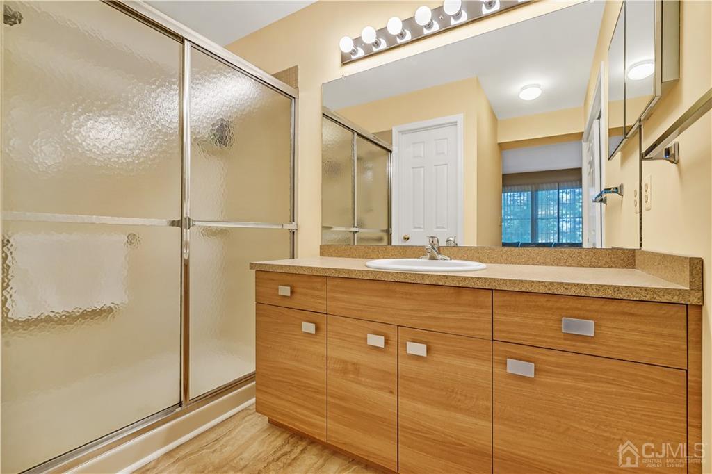 19 Stone Run Road Bedminster, NJ 07921 - Photo 11 of 17 a bathroom with a shower sink and mirror