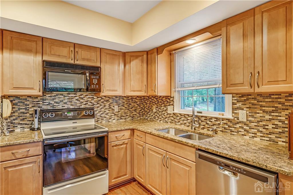 19 Stone Run Road Bedminster, NJ 07921 - Photo 6 of 17 a kitchen with granite countertop cabinets stainless steel appliances a sink and a counter top space