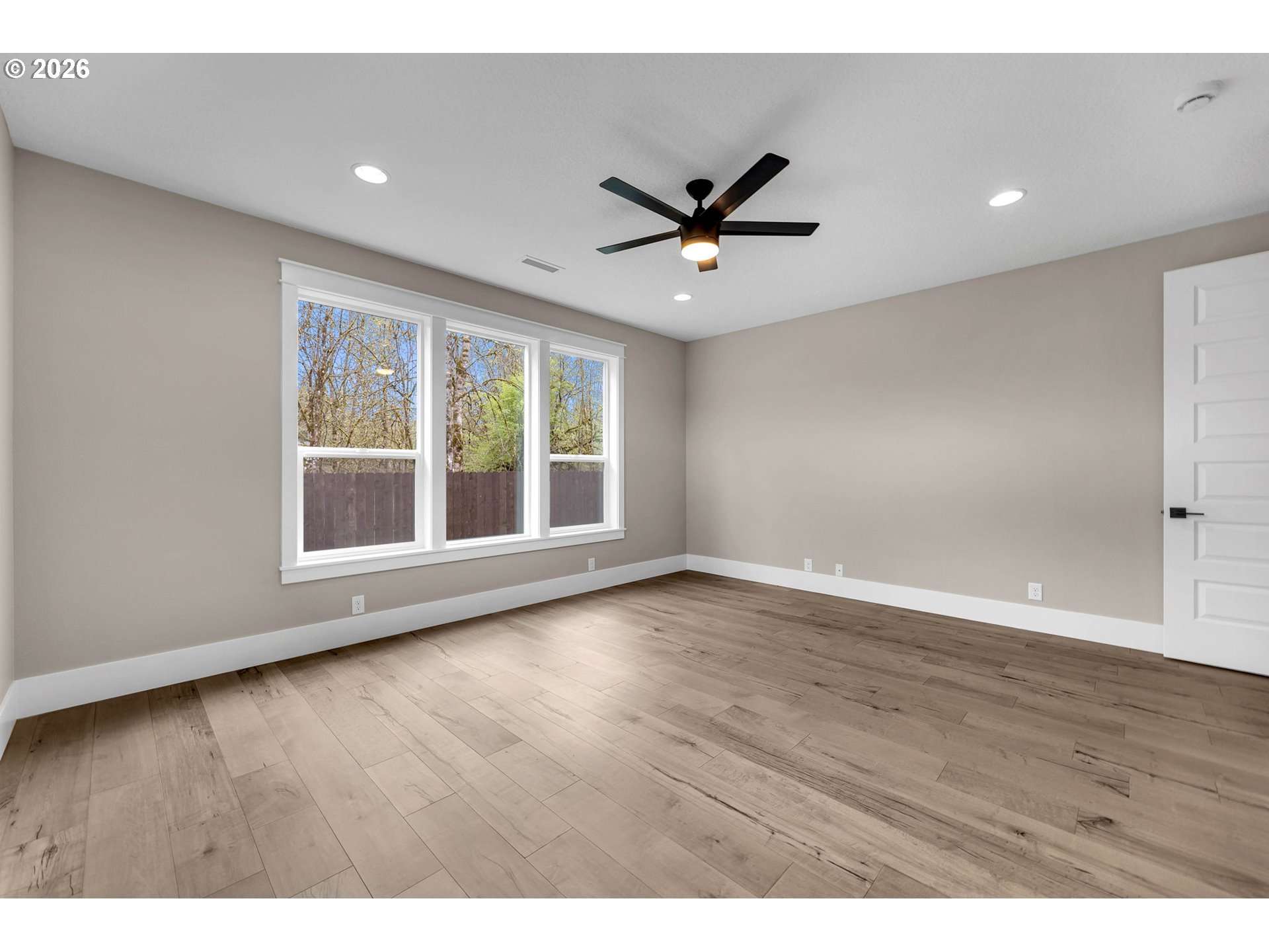 16221 Northeast 180th Street Brush Prairie, WA 98606 - Photo 21 of 47 a view of an empty room with wooden floor and a window