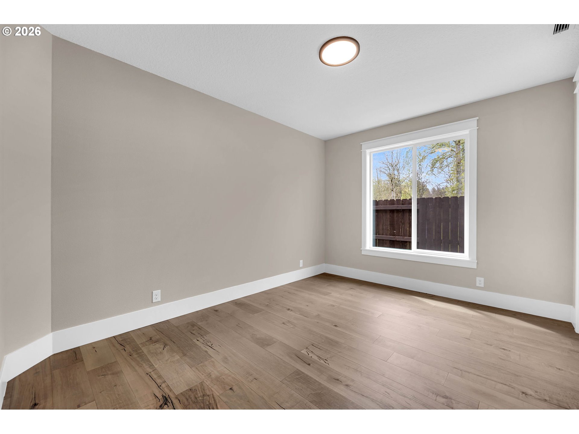16221 Northeast 180th Street Brush Prairie, WA 98606 - Photo 34 of 47 a view of an empty room with wooden floor and a window