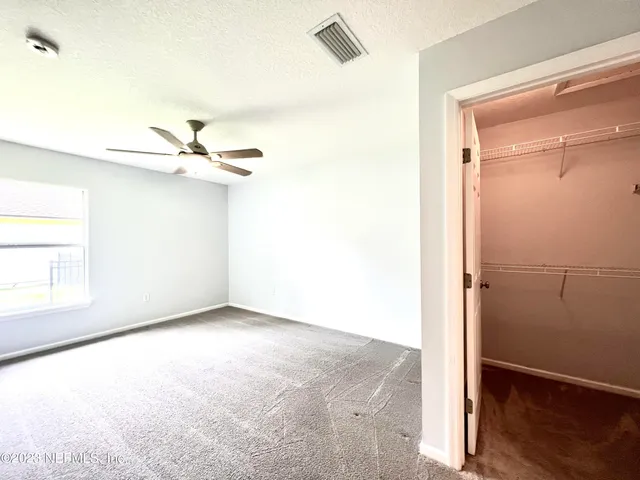 a view of a room with wooden floor closet and windows