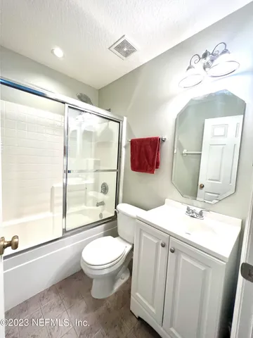 a bathroom with a toilet a sink and a mirror