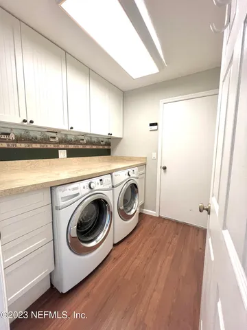 a utility room with sink dryer and washer