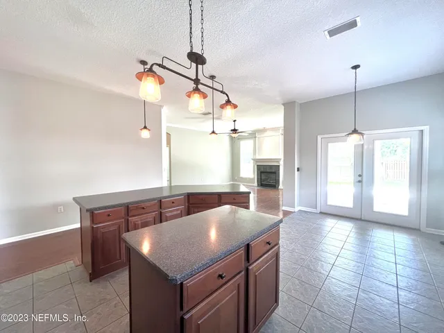 a kitchen with stainless steel appliances granite countertop a sink a counter space and cabinets