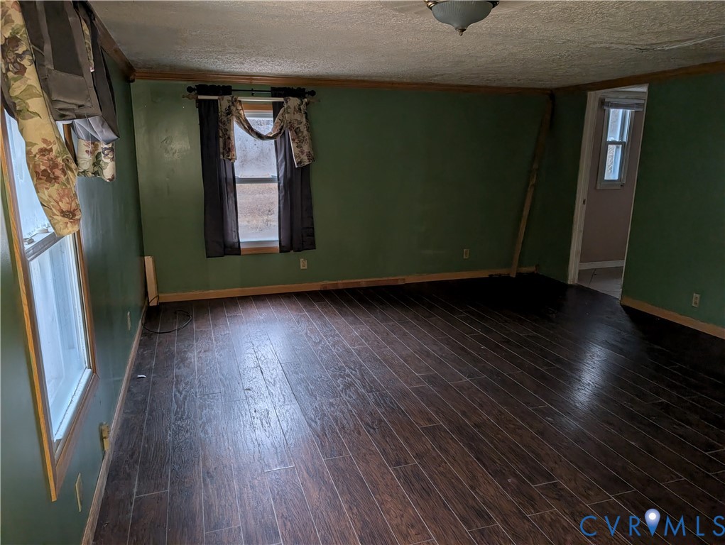 1149 Woodcrest Road Hurley, VA 24620 - Photo 12 of 32 a view of an empty room with wooden floor and a window