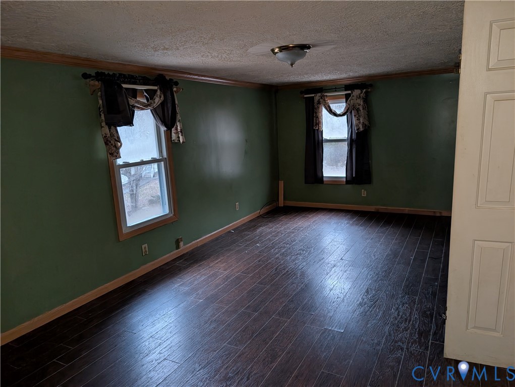 1149 Woodcrest Road Hurley, VA 24620 - Photo 13 of 32 an empty room with wooden floor and windows
