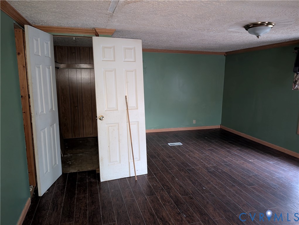 1149 Woodcrest Road Hurley, VA 24620 - Photo 14 of 32 an empty room with wooden floor and a hallway