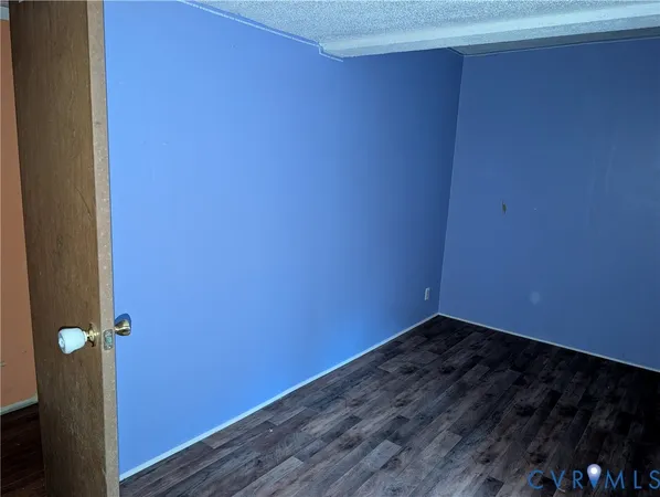 a view of a room with wooden floor and cabinets