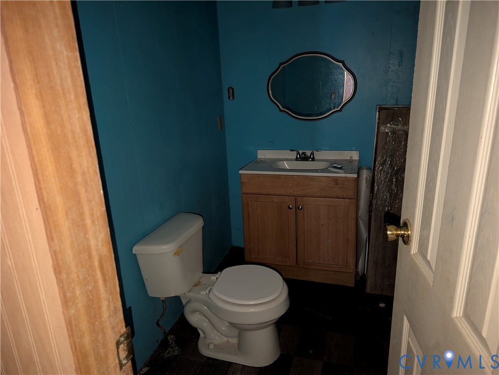 1149 Woodcrest Road Hurley, VA 24620 - Photo 19 of 32 a bathroom with a toilet a sink and a mirror