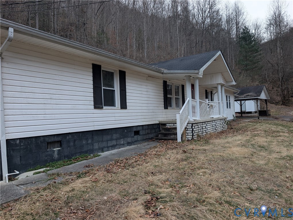1149 Woodcrest Road Hurley, VA 24620 - Photo 3 of 32 a view of a house with a yard and roof